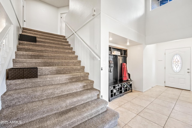 7949 W Pershing Ave, Peoria, AZ 85381 - foyer with stairway, a towering ceiling, light tile patterned floors, and baseboards