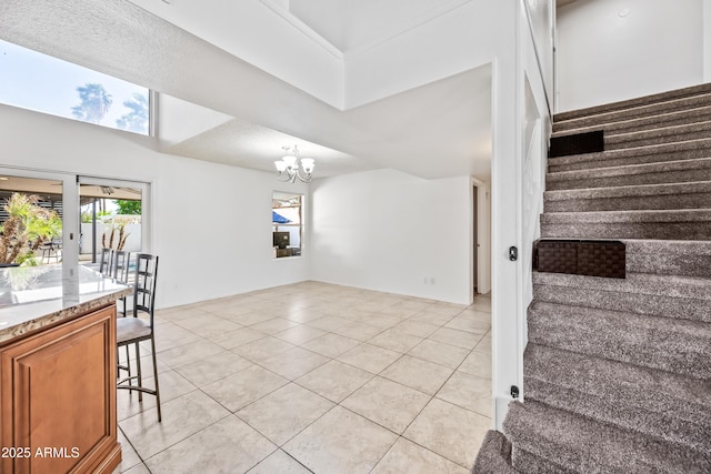 7949 W Pershing Ave, Peoria, AZ 85381 - stairs featuring tile patterned flooring, a chandelier, and a high ceiling