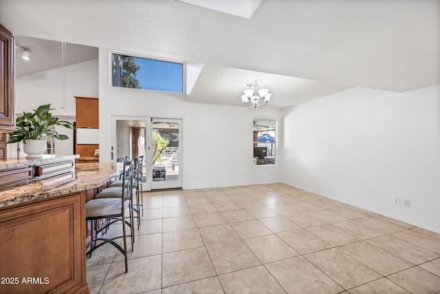 7949 W Pershing Ave, Peoria, AZ 85381 - dining space featuring a chandelier, light tile patterned floors, baseboards, and vaulted ceiling