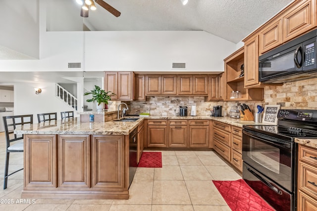 7949 W Pershing Ave, Peoria, AZ 85381 - kitchen with black appliances, vaulted ceiling, a breakfast bar area, decorative backsplash, and a peninsula