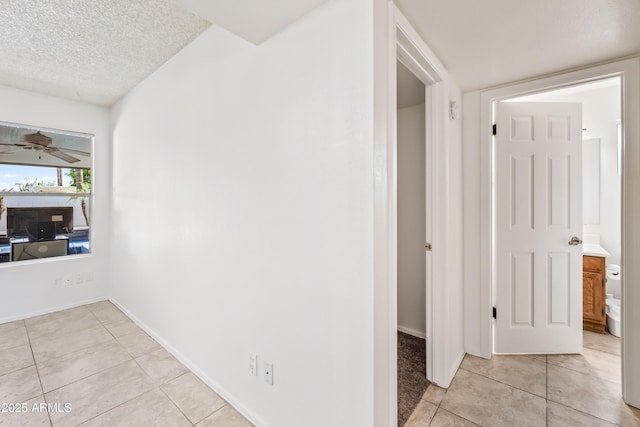 7949 W Pershing Ave, Peoria, AZ 85381 - hallway featuring light tile patterned floors, a textured ceiling, and baseboards