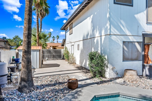 7949 W Pershing Ave, Peoria, AZ 85381 - view of home's exterior featuring a storage unit, an outdoor structure, and a patio area