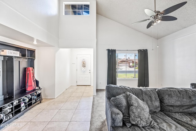 7949 W Pershing Ave, Peoria, AZ 85381 - living area with high vaulted ceiling, light tile patterned floors, ceiling fan, a textured ceiling, and baseboards