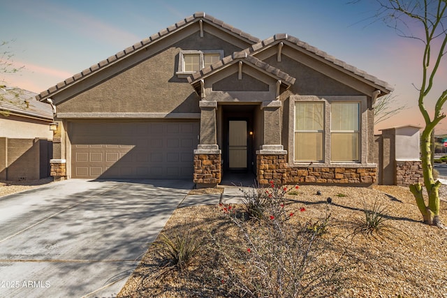 view of front of home featuring driveway, a garage, stone siding, fence, and stucco siding