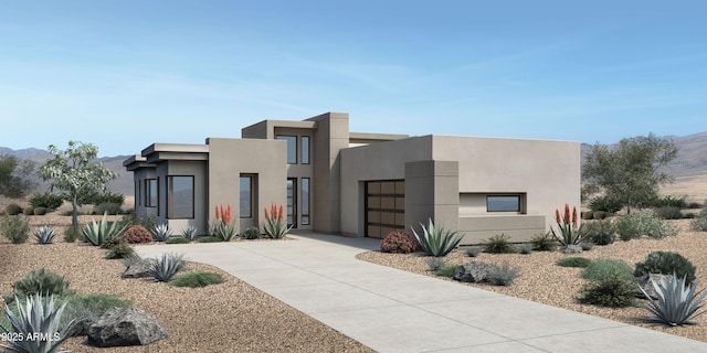 view of front facade featuring a mountain view, stucco siding, an attached garage, and driveway