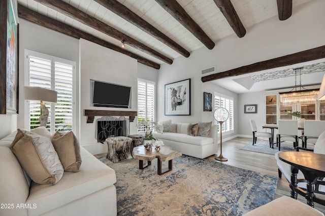 3109 E Sierra Madre Way, Phoenix, AZ 85016 - living room with wood finished floors, a wooden ceiling with exposed beams, a fireplace, and a chandelier