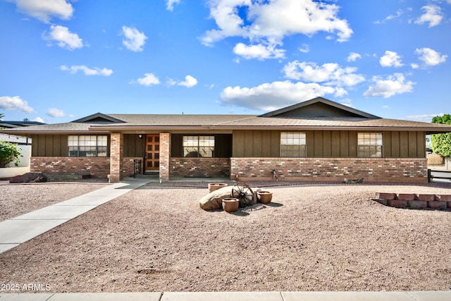 ranch-style home with brick siding and board and batten siding