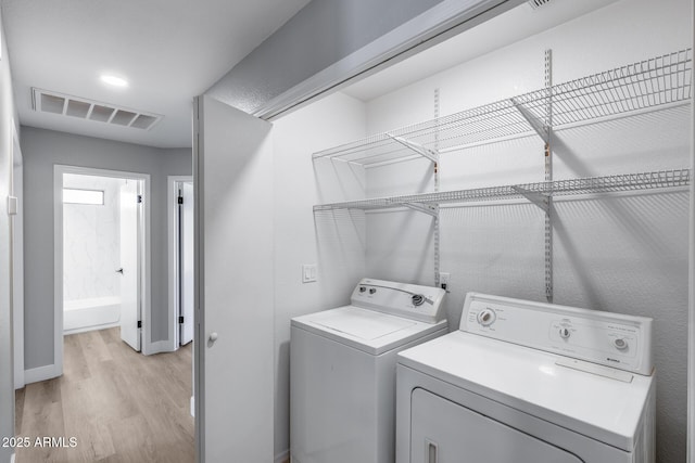 2730 E Desert Trumpet Rd, Phoenix, AZ 85048 - laundry area with separate washer and dryer, light wood finished floors, and baseboards