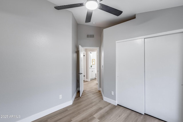 2730 E Desert Trumpet Rd, Phoenix, AZ 85048 - unfurnished bedroom featuring light wood-style flooring, a closet, baseboards, and a ceiling fan