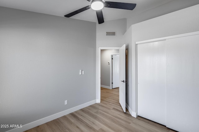 2730 E Desert Trumpet Rd, Phoenix, AZ 85048 - unfurnished bedroom with light wood finished floors, baseboards, a closet, and a ceiling fan