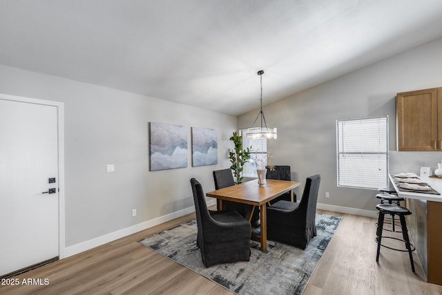 2730 E Desert Trumpet Rd, Phoenix, AZ 85048 - dining room with lofted ceiling, light wood-style floors, baseboards, and a chandelier