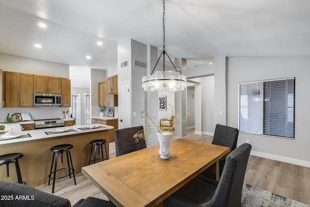 2730 E Desert Trumpet Rd, Phoenix, AZ 85048 - dining room featuring vaulted ceiling, light wood-type flooring, a chandelier, recessed lighting, and baseboards