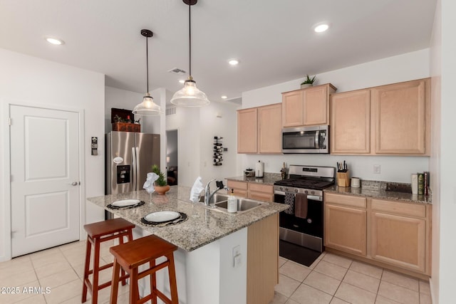 14233 W Georgia Dr, Surprise, AZ 85379 - kitchen featuring stainless steel appliances, a sink, light brown cabinetry, light tile patterned flooring, and recessed lighting