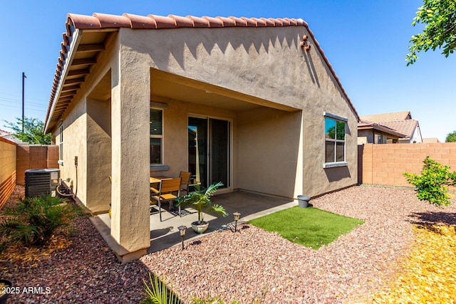 14233 W Georgia Dr, Surprise, AZ 85379 - rear view of property with central AC unit, stucco siding, a fenced backyard, and a patio area