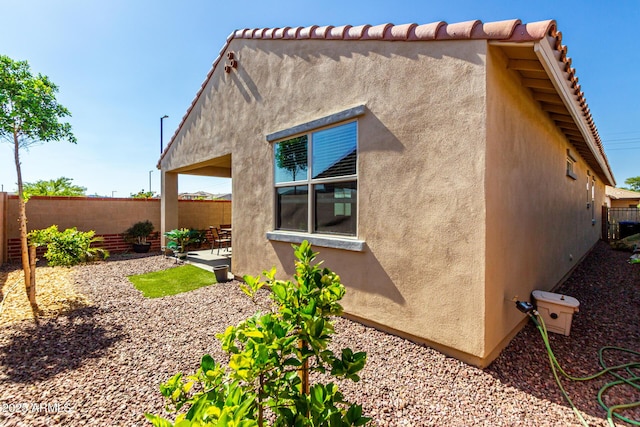 14233 W Georgia Dr, Surprise, AZ 85379 - view of side of home with stucco siding and a patio area