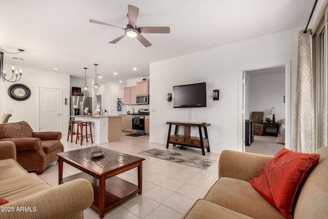 14233 W Georgia Dr, Surprise, AZ 85379 - living room featuring a ceiling fan, light tile patterned floors, recessed lighting, and a chandelier