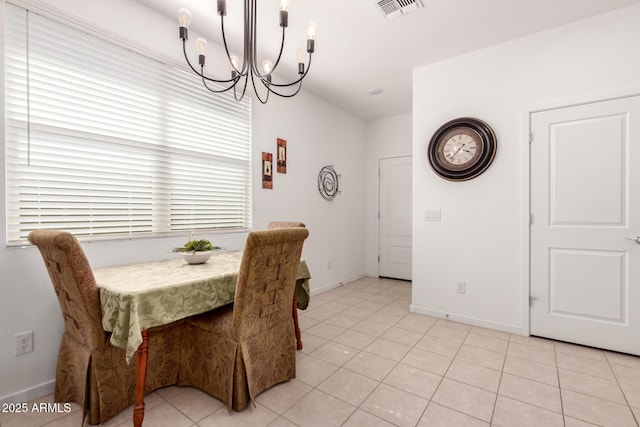 14233 W Georgia Dr, Surprise, AZ 85379 - dining area featuring a chandelier, light tile patterned flooring, and baseboards