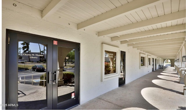 exterior space featuring stucco siding and french doors