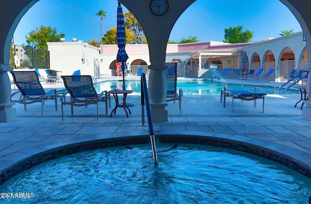 community pool featuring a patio area and fence