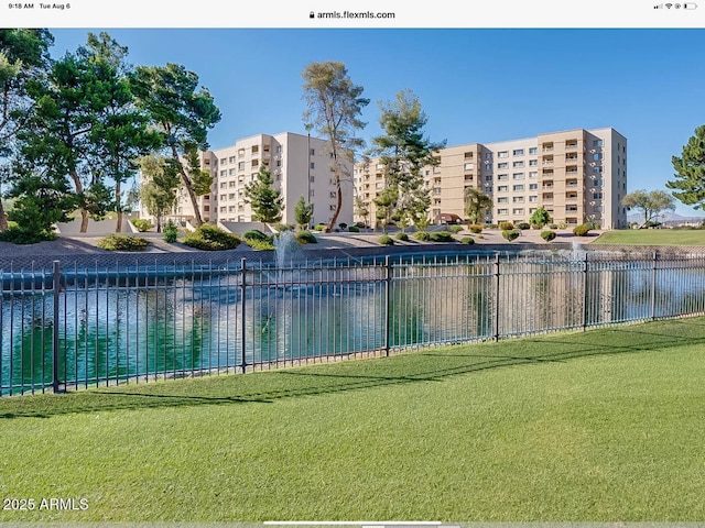 view of swimming pool with a lawn