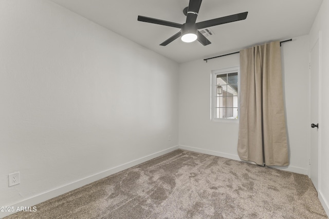 carpeted empty room with a ceiling fan, visible vents, and baseboards