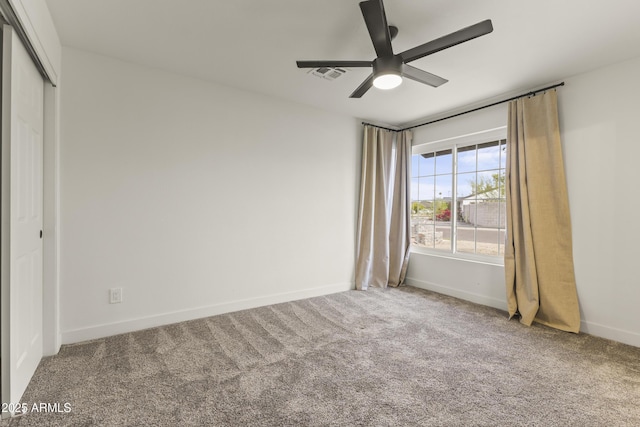 unfurnished bedroom with ceiling fan, visible vents, baseboards, a closet, and carpet