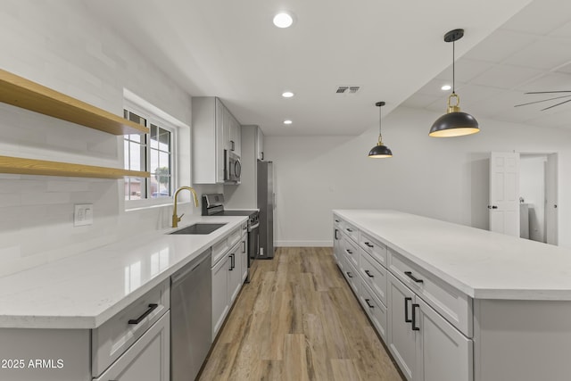 kitchen featuring recessed lighting, a sink, visible vents, appliances with stainless steel finishes, and light wood finished floors