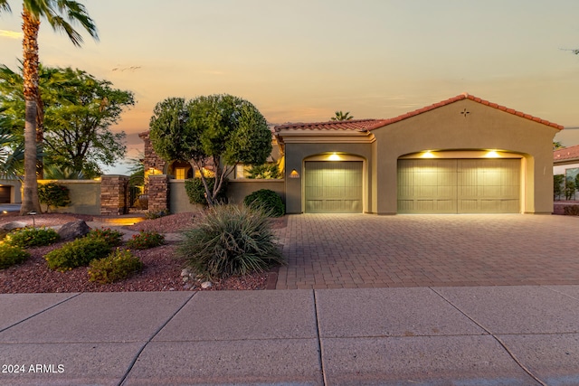 mediterranean / spanish home featuring a garage