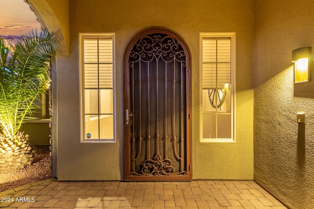 exterior entry at dusk with a fireplace