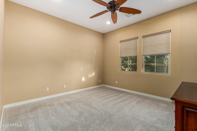 spare room featuring carpet floors and ceiling fan