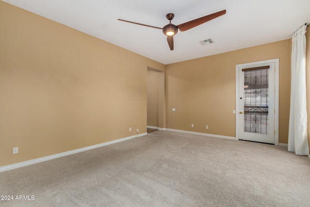 spare room with light carpet and ceiling fan