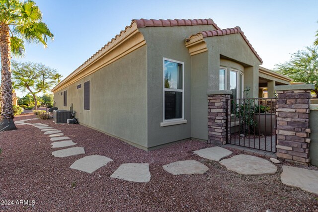 view of side of property with central AC