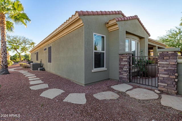 view of property exterior with central AC