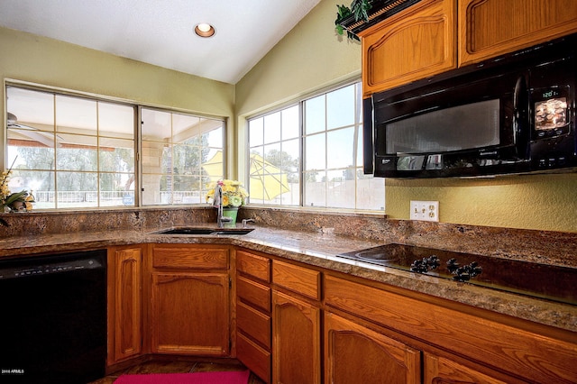 kitchen featuring lofted ceiling, sink, and black appliances