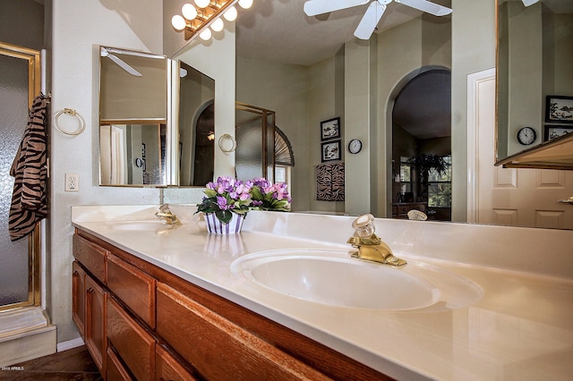 bathroom with ceiling fan and dual bowl vanity