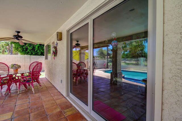 view of patio with ceiling fan and a fenced in pool