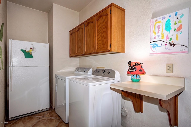 washroom with separate washer and dryer, cabinets, and tile patterned flooring