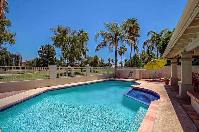 view of pool featuring a patio and an in ground hot tub