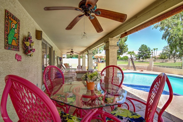 view of patio with ceiling fan and a fenced in pool