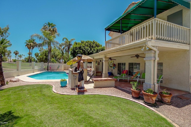 view of pool featuring a patio area, a lawn, and ceiling fan