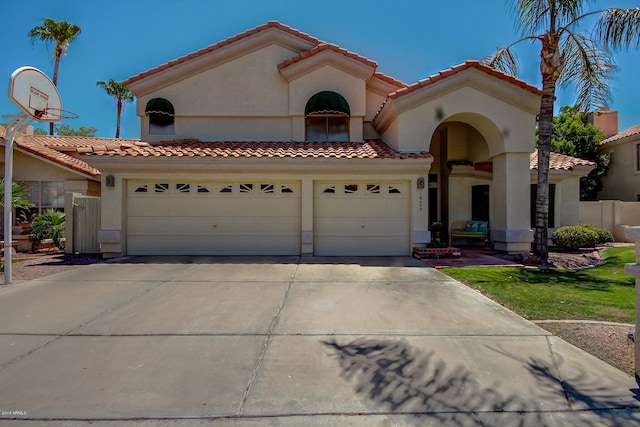 mediterranean / spanish-style house with a garage