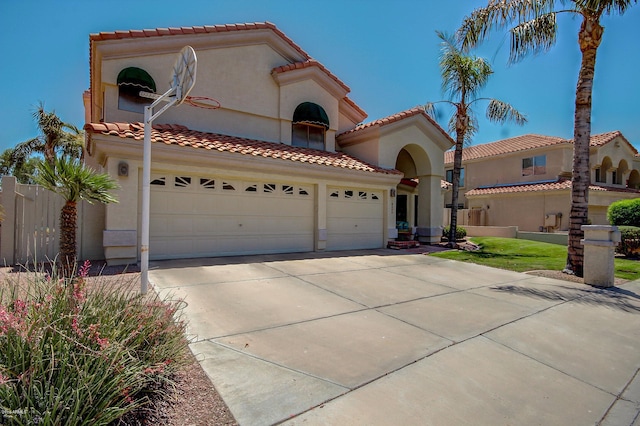 mediterranean / spanish-style home with a garage