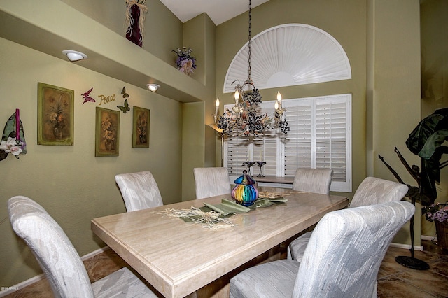 tiled dining space featuring a notable chandelier