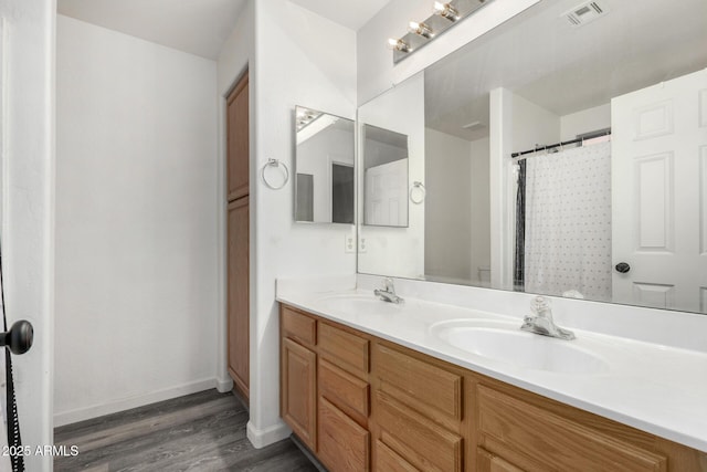 bathroom with vanity, curtained shower, and wood-type flooring