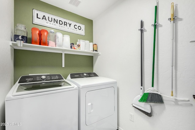 clothes washing area with washer and dryer