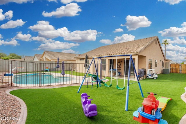 view of play area with a fenced in pool, central AC, a lawn, and a patio