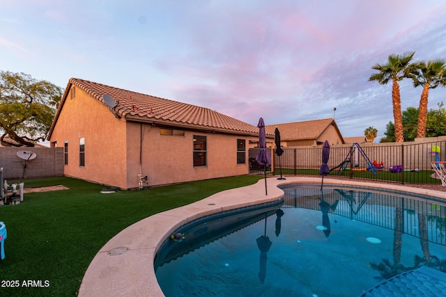 pool at dusk with a yard