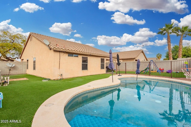 view of swimming pool featuring a lawn