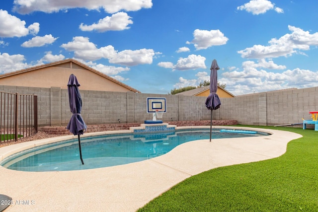 view of pool with a yard