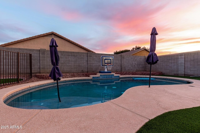 view of pool at dusk